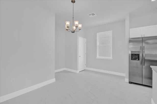 interior space featuring baseboards, marble finish floor, an inviting chandelier, and visible vents