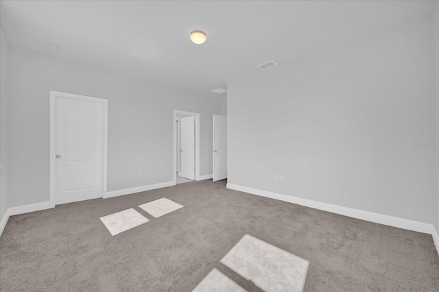 interior space featuring visible vents, baseboards, and carpet floors