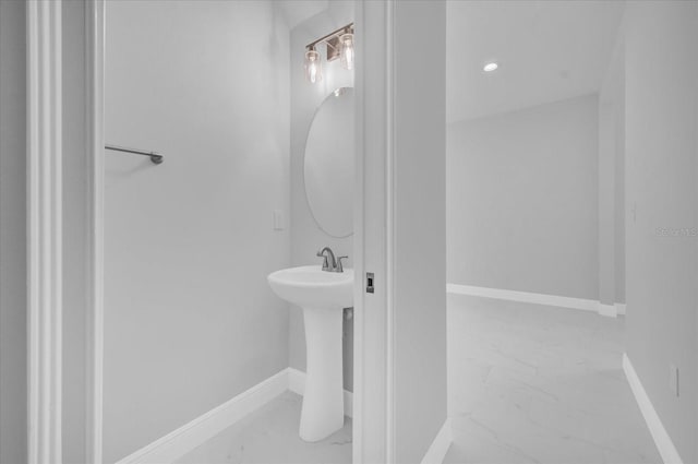 bathroom with baseboards and marble finish floor