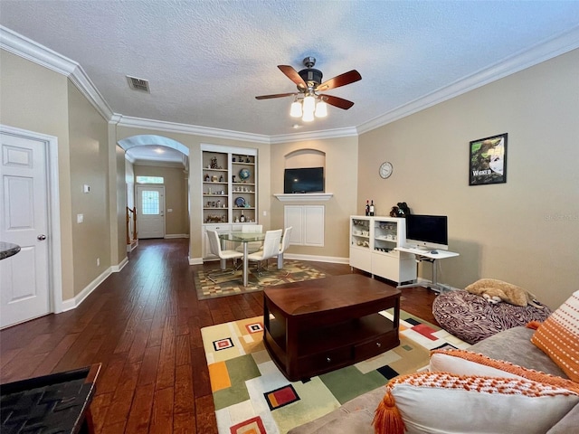 907 Pawstand Rd, Celebration, FL 34747 - living area with arched walkways, a ceiling fan, hardwood / wood-style flooring, crown molding, and baseboards