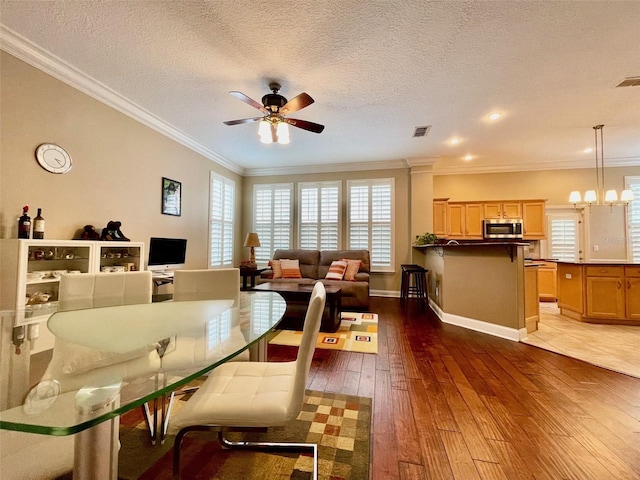 907 Pawstand Rd, Celebration, FL 34747 - living area featuring crown molding, hardwood / wood-style floors, ceiling fan, baseboards, and a chandelier