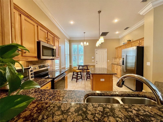 907 Pawstand Rd, Celebration, FL 34747 - kitchen with appliances with stainless steel finishes, a sink, a chandelier, light tile patterned flooring, and tasteful backsplash