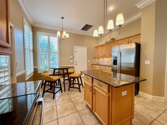 907 Pawstand Rd, Celebration, FL 34747 - kitchen with a chandelier, decorative backsplash, stainless steel appliances, ornamental molding, and light tile patterned flooring