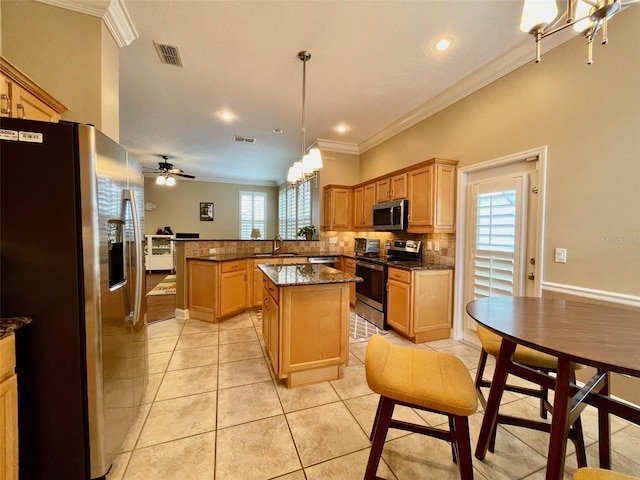 907 Pawstand Rd, Celebration, FL 34747 - kitchen featuring stainless steel appliances, a sink, ornamental molding, a peninsula, and light tile patterned floors
