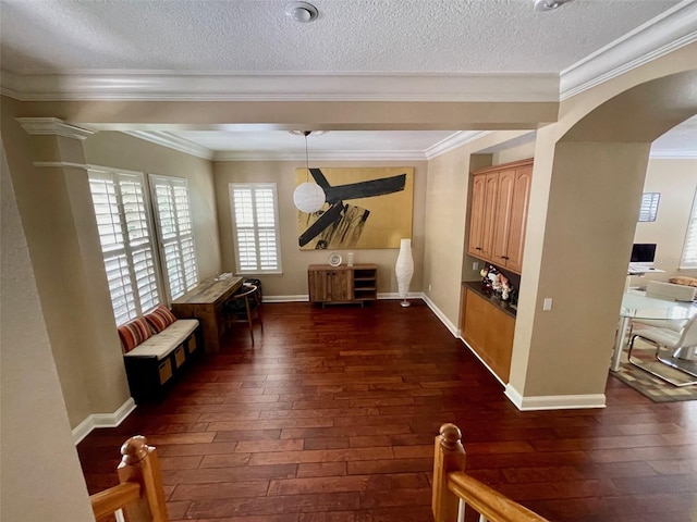 907 Pawstand Rd, Celebration, FL 34747 - unfurnished room with dark wood-style floors, arched walkways, crown molding, a textured ceiling, and baseboards
