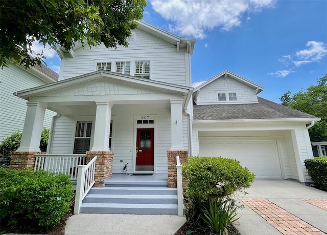 907 Pawstand Rd, Celebration, FL 34747 - view of front of property featuring a porch, an attached garage, concrete driveway, and a shingled roof