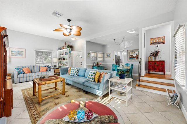 living room featuring light tile patterned flooring, a ceiling fan, and visible vents