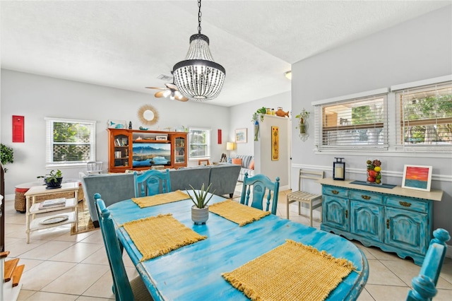 dining space featuring light tile patterned floors, a chandelier, visible vents, and a healthy amount of sunlight