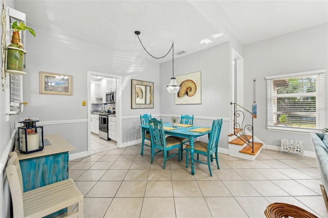 dining area with light tile patterned floors and baseboards