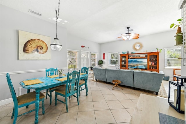 dining room featuring a ceiling fan, light tile patterned flooring, and a healthy amount of sunlight