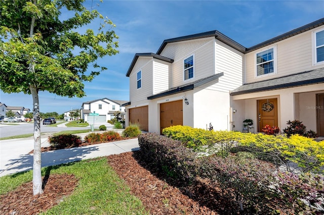 5424 Companion Ln, Tampa, FL 33619 - view of side of home with an attached garage, stucco siding, a residential view, and concrete driveway