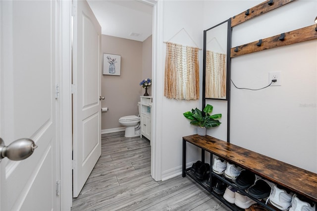 5424 Companion Ln, Tampa, FL 33619 - bathroom with toilet, baseboards, and wood finished floors