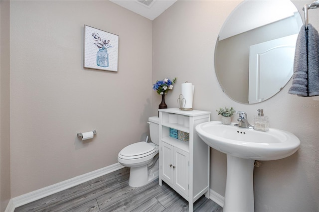 5424 Companion Ln, Tampa, FL 33619 - half bath with toilet, baseboards, and wood finished floors