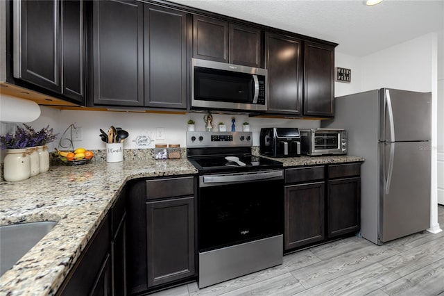 5424 Companion Ln, Tampa, FL 33619 - kitchen with appliances with stainless steel finishes, light wood-style floors, light stone countertops, and a sink
