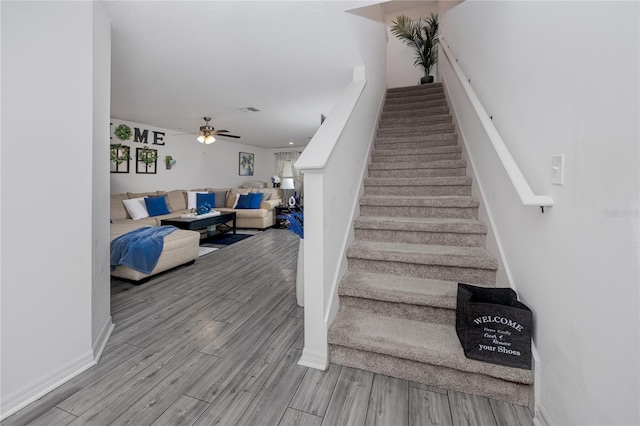 5424 Companion Ln, Tampa, FL 33619 - staircase featuring wood finished floors, a ceiling fan, and baseboards