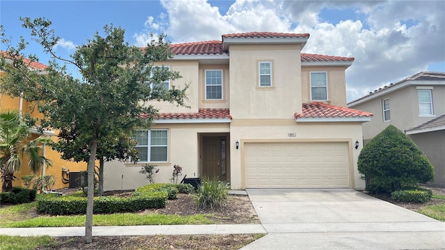 6041 Broad Oak Dr, Davenport, FL 33837 - mediterranean / spanish-style home with a tile roof, driveway, a garage, and stucco siding