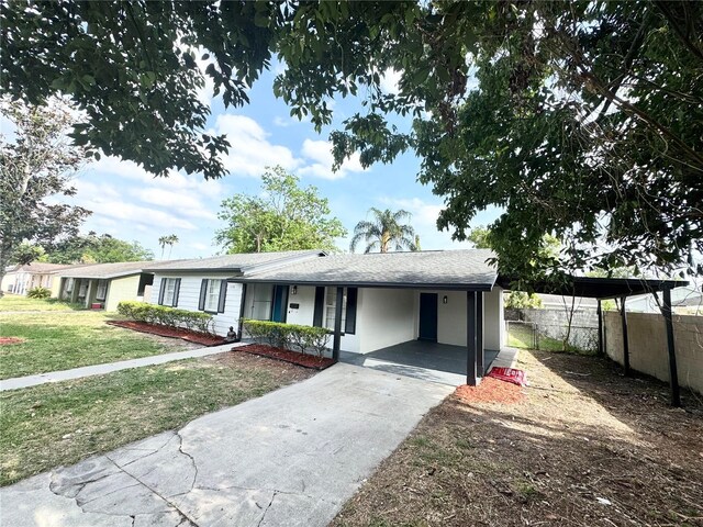 1098 Leeway Ct, Orlando, FL 32810 - single story home featuring a front lawn, concrete driveway, fence, and a carport