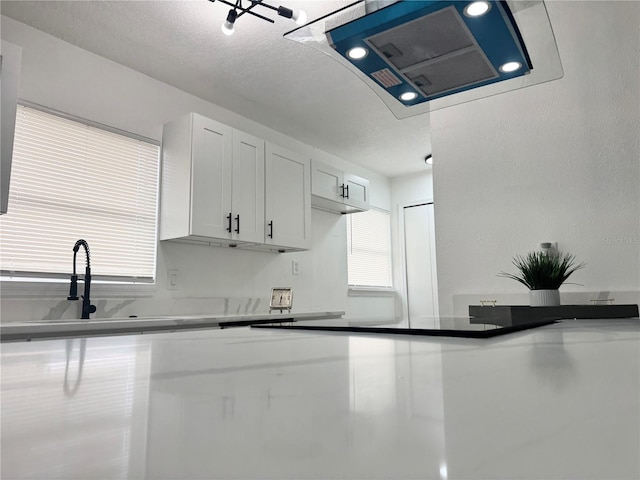 1098 Leeway Ct, Orlando, FL 32810 - kitchen featuring a sink, extractor fan, and white cabinets