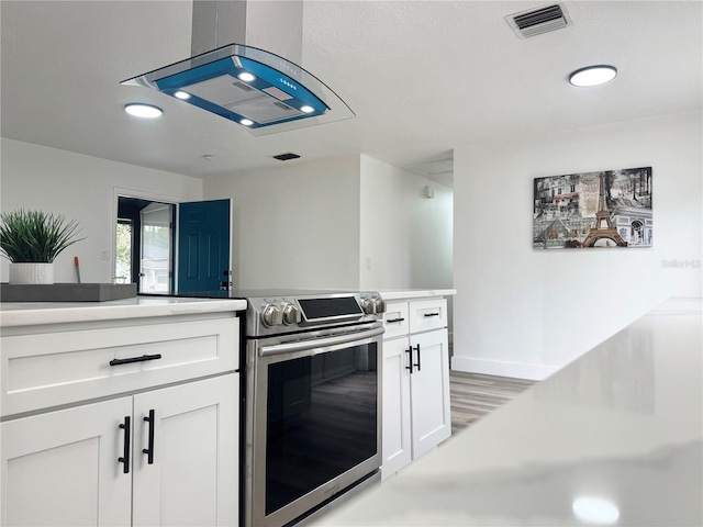 1098 Leeway Ct, Orlando, FL 32810 - kitchen with white cabinetry, visible vents, electric stove, light countertops, and light wood-style floors