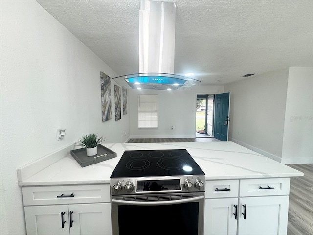 1098 Leeway Ct, Orlando, FL 32810 - kitchen with stainless steel electric range oven, island range hood, open floor plan, and a textured ceiling
