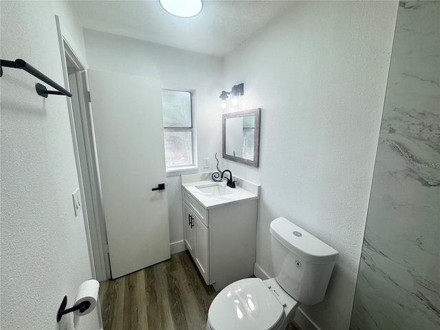 1098 Leeway Ct, Orlando, FL 32810 - bathroom featuring toilet, vanity, a textured wall, and wood finished floors