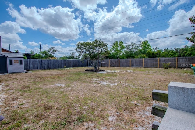 view of yard featuring an outdoor structure and a fenced backyard