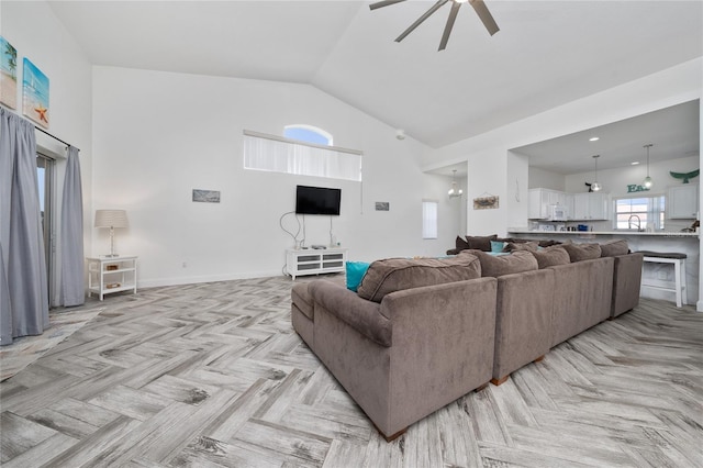 2902 Paddington Way, Kissimmee, FL 34747 - living area featuring ceiling fan, high vaulted ceiling, and baseboards