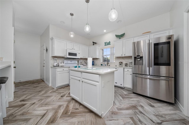 2902 Paddington Way, Kissimmee, FL 34747 - kitchen with white appliances, white cabinetry, light countertops, decorative light fixtures, and recessed lighting