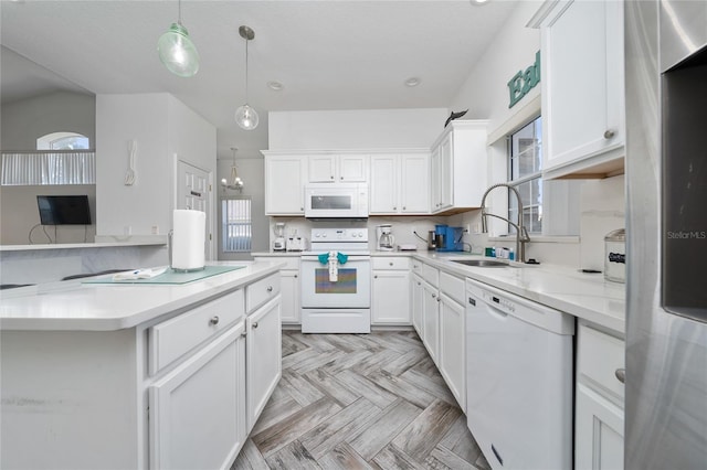 2902 Paddington Way, Kissimmee, FL 34747 - kitchen with white appliances, a sink, light countertops, and white cabinetry