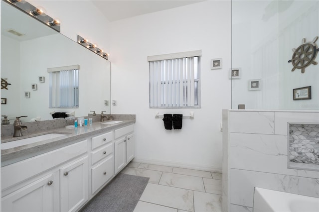 2902 Paddington Way, Kissimmee, FL 34747 - full bathroom with marble look tiles, a bath, double vanity, baseboards, and healthy amount of natural light