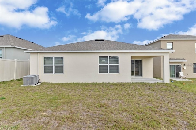 back of property featuring a lawn, fence, central AC, a patio area, and stucco siding