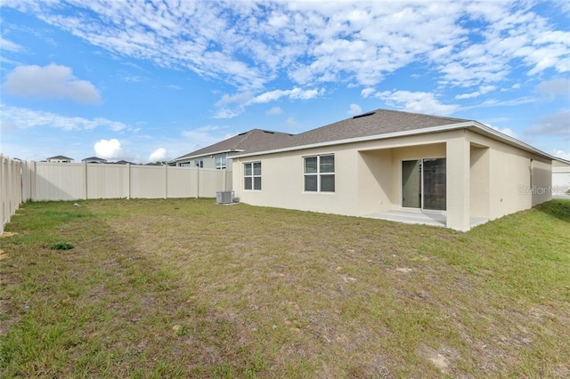 rear view of property with stucco siding, central air condition unit, and a patio