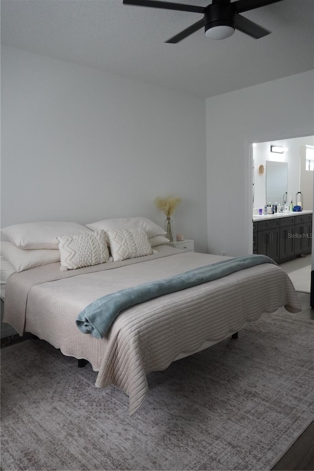 bedroom with connected bathroom and a ceiling fan