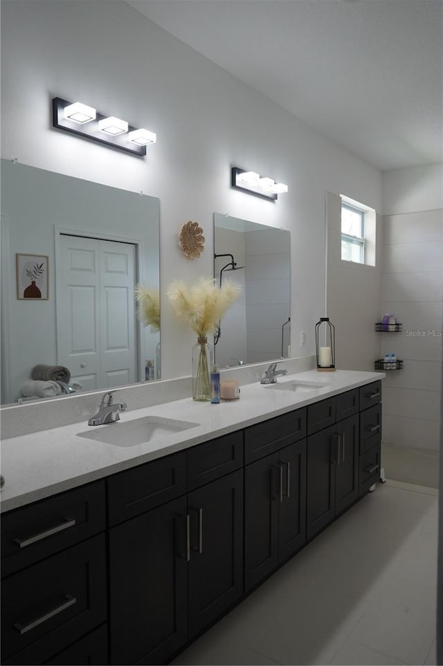 bathroom featuring a sink and double vanity