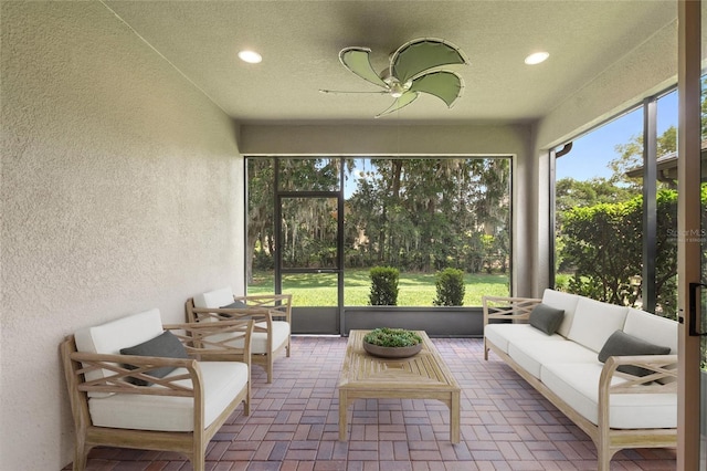sunroom featuring an outdoor hangout area and ceiling fan