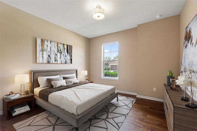 bedroom featuring wood finished floors and baseboards