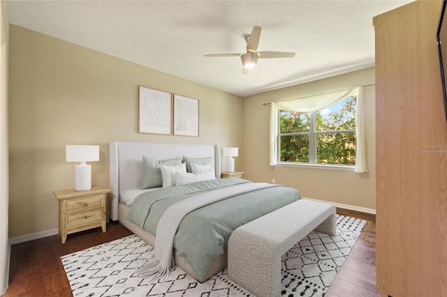 bedroom featuring baseboards, dark wood-type flooring, and ceiling fan