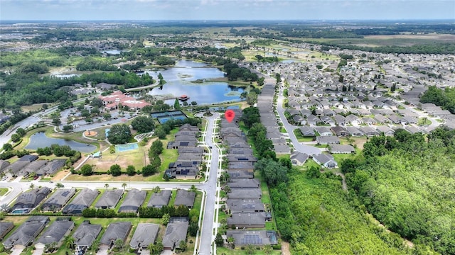 aerial view of property's location featuring nearby suburban area and a nearby body of water