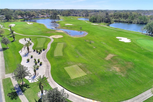 aerial view of a nearby body of water, a tree filled landscape, and a golf course