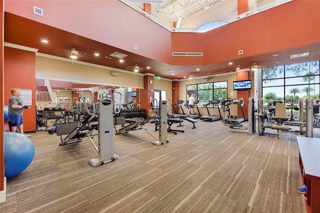 workout area featuring carpet flooring, a towering ceiling, and recessed lighting