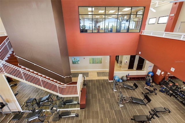 workout area featuring a towering ceiling