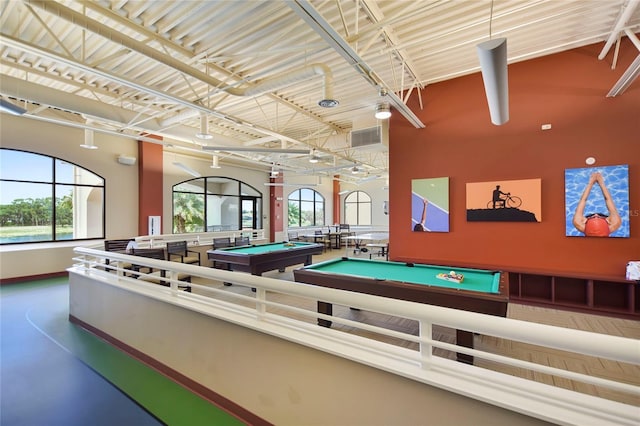 recreation room with billiards, baseboards, and healthy amount of natural light