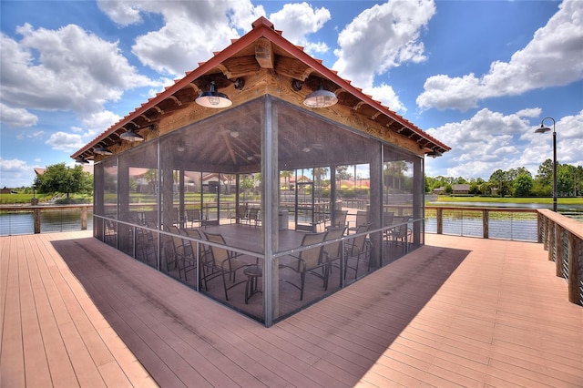 dock area with a gazebo and a deck with water view