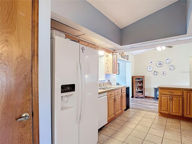 3110 Short Leaf Pine Ct, Kissimmee, FL 34746 - kitchen featuring white appliances, a sink, light tile patterned floors, light countertops, and brown cabinetry
