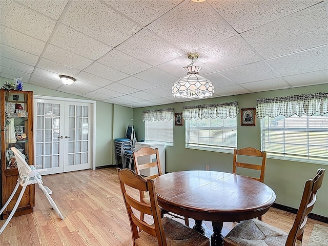 3110 Short Leaf Pine Ct, Kissimmee, FL 34746 - dining area with french doors, light wood finished floors, a drop ceiling, and baseboards