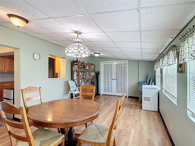 3110 Short Leaf Pine Ct, Kissimmee, FL 34746 - dining area with a drop ceiling, light wood-style floors, french doors, and baseboards