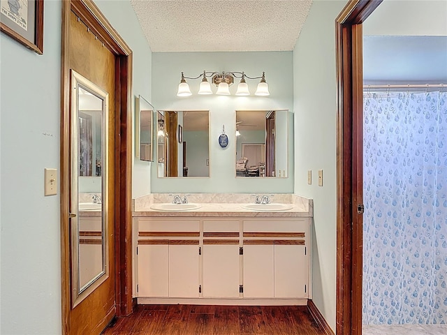 3110 Short Leaf Pine Ct, Kissimmee, FL 34746 - full bath with double vanity, wood finished floors, a textured ceiling, and curtained shower