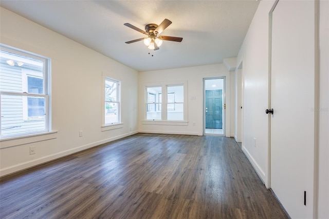 1007 11th St, Saint Cloud, FL 34769 - spare room featuring baseboards, a ceiling fan, and dark wood-style floors