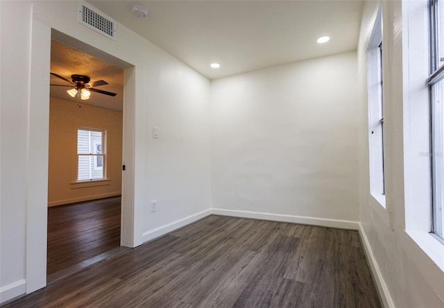 1007 11th St, Saint Cloud, FL 34769 - spare room with a ceiling fan, baseboards, visible vents, and dark wood-style floors