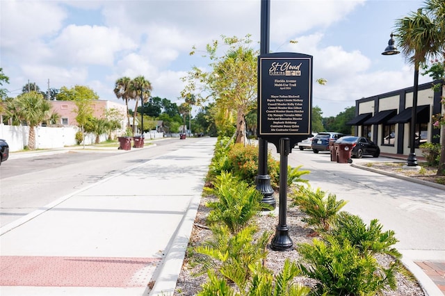 1007 11th St, Saint Cloud, FL 34769 - view of concrete road with curbs, street lights, and sidewalks